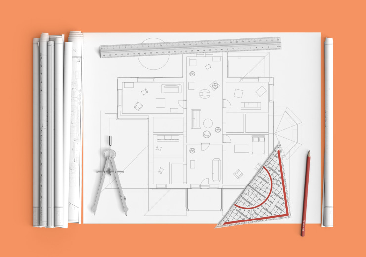 A floor plan on paper with a pencil, a ruler and a compass